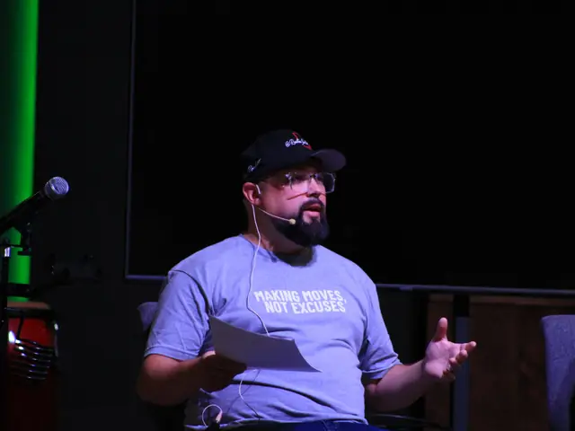 A speaker with a headset microphone sharing a story on stage