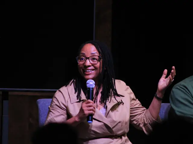 A guest speaker smiling and sharing on stage